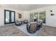 Rear covered patio features tile flooring and modern seating, perfect for outdoor enjoyment at 2365 Novus St, Sarasota, FL 34237