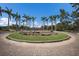 Circular flowerbed in Payne Park surrounded by sidewalks and palm trees at 2365 Novus St, Sarasota, FL 34237