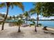 Picturesque waterfront with picnic tables, palm trees, and city buildings offering an idyllic coastal setting at 2365 Novus St, Sarasota, FL 34237