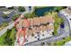 Aerial view of townhouses with well maintained roofs and beautiful landscaping, showcasing a garage and parking spots at 2609 Waterford Way # B, Palmetto, FL 34221