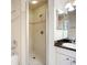 Bright bathroom features shower stall with glass door and vanity with granite countertop at 2609 Waterford Way # B, Palmetto, FL 34221