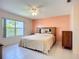 The bedroom features tile flooring, a ceiling fan, and a large window for natural light at 2609 Waterford Way # B, Palmetto, FL 34221