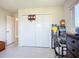 Bright bedroom featuring a closet with a basketball hoop and a desk piled with games at 2609 Waterford Way # B, Palmetto, FL 34221