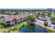 A beautiful multi-Gathering exterior view with a serene pond and lush landscaping, creating a tranquil community setting at 2609 Waterford Way # B, Palmetto, FL 34221