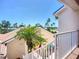 View from the townhome entrance, with lush palm trees, manicured lawns, and tropical landscaping at 2609 Waterford Way # B, Palmetto, FL 34221