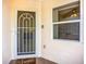 Close up of a white security door featuring tile flooring and a beige painted exterior at 2609 Waterford Way # B, Palmetto, FL 34221