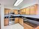 Updated kitchen features stainless steel appliances, tile flooring and dark countertops at 2609 Waterford Way # B, Palmetto, FL 34221