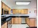 Bright kitchen features stainless steel appliances, tile flooring and dark granite countertops at 2609 Waterford Way # B, Palmetto, FL 34221