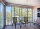Enclosed lanai featuring a tile floor and outdoor seating with a view of lush greenery at 2609 Waterford Way # B, Palmetto, FL 34221