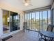 Enclosed lanai with tiled floors, offering seating and views of the surrounding community and the bay at 2609 Waterford Way # B, Palmetto, FL 34221