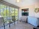 Screened lanai featuring a ceiling fan, outdoor furniture, and view of a tranquil landscape at 2609 Waterford Way # B, Palmetto, FL 34221