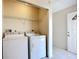 Well-lit laundry room featuring a washer, a dryer, wire shelving and access to the outside at 2609 Waterford Way # B, Palmetto, FL 34221