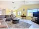 Spacious living room with tile floors, neutral walls, a ceiling fan, and comfortable seating at 2609 Waterford Way # B, Palmetto, FL 34221