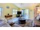 Bright living room with comfortable seating, ceiling fan, and sliding door to outdoor living space at 2609 Waterford Way # B, Palmetto, FL 34221