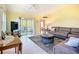Cozy living room featuring tile flooring, ceiling fan, and access to the balcony at 2609 Waterford Way # B, Palmetto, FL 34221