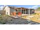 Backyard area with wooden patio, orange outdoor seating, and a screened in patio at 2705 20Th Avenue W Dr, Bradenton, FL 34205
