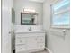 Modern bathroom with a white vanity, marble backsplash, and a framed mirror at 2705 20Th Avenue W Dr, Bradenton, FL 34205