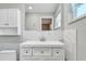 Bright bathroom featuring a modern white vanity with marble accent wall, and a toilet at 2705 20Th Avenue W Dr, Bradenton, FL 34205