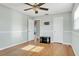 Bedroom with hardwood floors, ceiling fan and access to ensuite bathroom at 2705 20Th Avenue W Dr, Bradenton, FL 34205