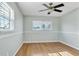 Bedroom with hardwood floors, large windows, and ceiling fan at 2705 20Th Avenue W Dr, Bradenton, FL 34205
