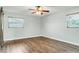 Bedroom featuring natural light through windows with hardwood floors and a ceiling fan at 2705 20Th Avenue W Dr, Bradenton, FL 34205