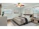 Bright bedroom features a ceiling fan, hardwood floors, two windows, and artwork that adds to the room's charm at 2705 20Th Avenue W Dr, Bradenton, FL 34205