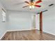 Bright bedroom featuring wood-look floors, a ceiling fan, and a stylish sliding barn door to the ensuite bathroom at 2705 20Th Avenue W Dr, Bradenton, FL 34205