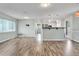 Open-concept living room with hardwood floors that flows seamlessly into a kitchen with modern countertops and stainless appliances at 2705 20Th Avenue W Dr, Bradenton, FL 34205