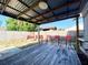 Backyard area with wooden patio, red outdoor seating, and a wooden fence at 2705 20Th Avenue W Dr, Bradenton, FL 34205