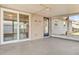 Enclosed patio with concrete flooring, a sliding glass door, and a blue entry door at 2705 20Th Avenue W Dr, Bradenton, FL 34205