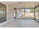 Screened-in patio overlooking the backyard, featuring concrete flooring and an attached light fixture at 2705 20Th Avenue W Dr, Bradenton, FL 34205