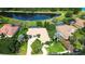 Beautiful aerial view of home with mature landscaping and a pond view at 3201 Wilderness W Blvd, Parrish, FL 34219