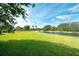 Lush green backyard with a scenic waterfront view, ideal for relaxation and recreation at 3201 Wilderness W Blvd, Parrish, FL 34219