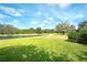 Spacious backyard with a tranquil lake view, perfect for outdoor activities at 3201 Wilderness W Blvd, Parrish, FL 34219