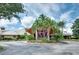 Stunning clubhouse entrance with palm trees, flowers and circular driveway at 3201 Wilderness W Blvd, Parrish, FL 34219