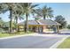 Community guard house surrounded by lush tropical landscaping and beautiful flowerbeds at 3201 Wilderness W Blvd, Parrish, FL 34219