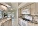 Bright kitchen featuring granite countertops and backsplash, and white appliances at 3201 Wilderness W Blvd, Parrish, FL 34219