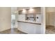 Bright kitchen featuring granite countertops, white appliances, and an adjacent dining area at 3201 Wilderness W Blvd, Parrish, FL 34219