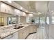 Bright kitchen featuring granite countertops, stainless steel sink and faucet, and white appliances at 3201 Wilderness W Blvd, Parrish, FL 34219