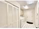 Well-lit laundry room featuring a washer, dryer, cabinets, and closet for ample storage at 3201 Wilderness W Blvd, Parrish, FL 34219