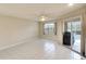 Bright living room featuring tile flooring, a ceiling fan, and sliding glass doors at 3201 Wilderness W Blvd, Parrish, FL 34219