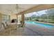 Relaxing screened patio with an outdoor dining area overlooking the private pool at 3201 Wilderness W Blvd, Parrish, FL 34219