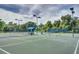 Well-maintained tennis courts surrounded by lush landscaping with shade areas and lighting at 3201 Wilderness W Blvd, Parrish, FL 34219