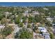 Scenic aerial shot showcases a leafy neighborhood with homes nestled among mature trees and a waterfront view at 3209 2Nd W Ave, Bradenton, FL 34205