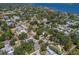 Aerial view of a neighborhood with lush green trees and glimpses of the waterfront in the background at 3209 2Nd W Ave, Bradenton, FL 34205