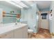 Bright bathroom with a white vanity, terracotta tile floor, and a glass enclosed shower at 3209 2Nd W Ave, Bradenton, FL 34205
