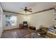 Cozy bedroom with a ceiling fan, a window view, and eclectic decor at 3209 2Nd W Ave, Bradenton, FL 34205