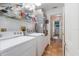 Laundry room featuring a washer, dryer, and tile floor, with storage shelves at 3209 2Nd W Ave, Bradenton, FL 34205