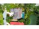 Stunning aerial view of estate home with pool, lush landscaping, and circular driveway on the water at 3302 Sabal Cove Ln, Longboat Key, FL 34228
