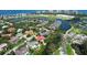 Expansive aerial shot of waterfront community, golf course, and luxurious residences amid lush greenery at 3302 Sabal Cove Ln, Longboat Key, FL 34228